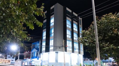 a tall building at night with lights at Sky Suite in Sogamoso