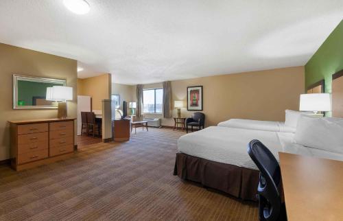 a large hotel room with a bed and a desk at Extended Stay America Select Suites - Madison - Old Sauk Rd in Madison