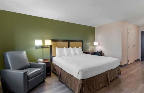a hotel room with a bed and a chair at Extended Stay America Suites - Fremont - Warm Springs in Warm Springs District
