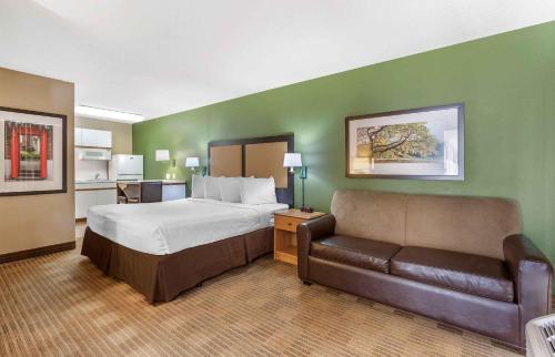 a hotel room with a bed and a couch at Extended Stay America Select Suites - Phoenix - Mesa - West in Mesa