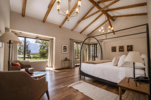 a bedroom with a bed and a living room at Sierra Sacred Valley in Urubamba