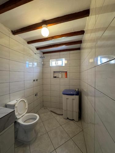 a bathroom with a toilet and a trash can at Mida creek front one bedroom in Watamu