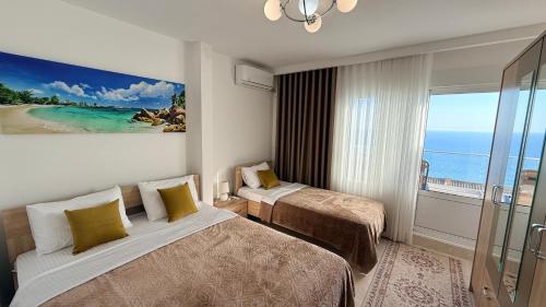 a hotel room with two beds and a view of the ocean at Sea&Sun Living in Ulcinj