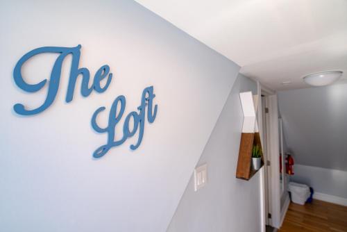 a sign on a wall that reads the gut at Silver Lining Inn and Motel in Chéticamp