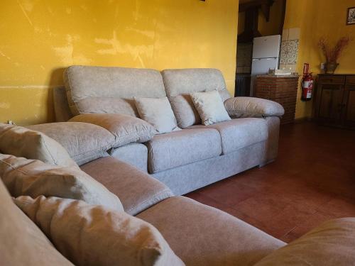 a couch in a living room with two pillows on it at Villa in Andalusia with Private Pool in Fuentes de Cesna