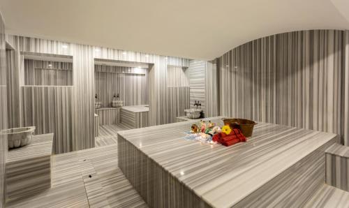 a room with a table with a bowl of fruit on it at Wise Hotel & Spa - Adults Only in Antalya