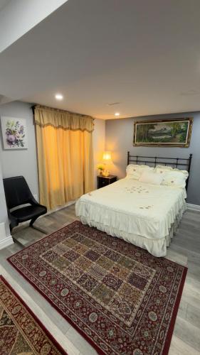 a bedroom with a bed and a chair and a rug at Beautiful lake view Basment room in Brampton
