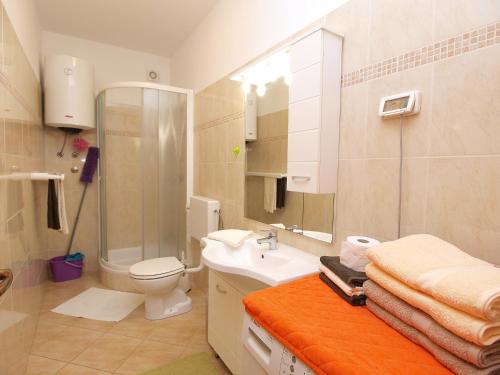 a bathroom with a shower toilet and a sink at Apartments Fazanka 849 in Fažana