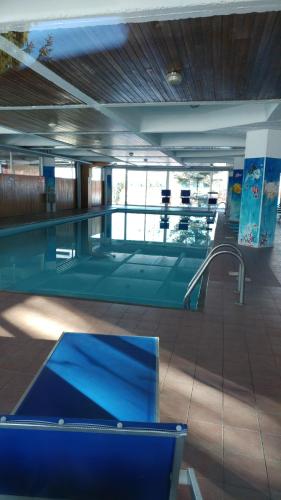 a swimming pool with a blue table in a building at Apartment Ski Marilleva 1400 in Marilleva