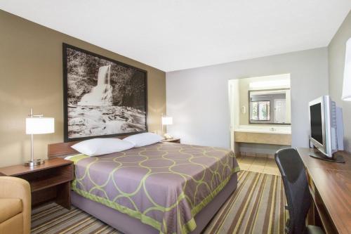 A bed or beds in a room at Super 8 by Wyndham Wytheville