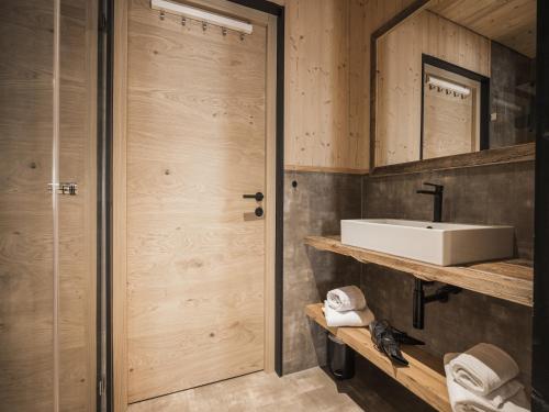 a bathroom with a sink and a mirror at Modern chalet with sauna, Dein Bichlbach in Bichlbach