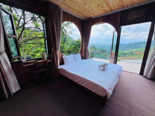 a bedroom with a bed with a cat laying on it at Mimoza homestay cầu đất in Xuân Trường