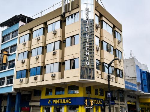 a building with a clock on the side of it at Hotel Milenio in Guayaquil