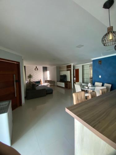 a large living room with a couch and a table at Casa para temporada Diversão e sossego PRÓXIMA A PRAIA in Rio das Ostras