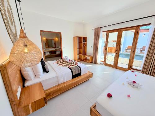a bedroom with a bed and a view of the ocean at Yamore Villa in Gili Islands