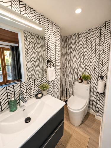 a bathroom with a white sink and a toilet at Evergreen House in Vancouver