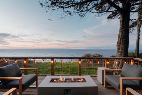 a fire pit on a deck with a view of the ocean at Private Blufftop Oceanview Hot Tub Fire Pit in Port Angeles