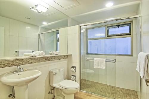 a bathroom with a toilet and a sink and a shower at Balmoral Hotel San José CR, Historic District in San José