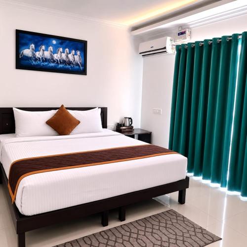 a bedroom with a bed and green curtains at HOTEL SQUARE INN Cosmopolitan in Bangalore