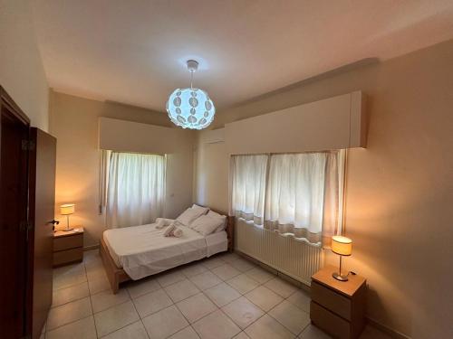 a bedroom with a bed and a chandelier at Theodorou Town Residence in Strovolos