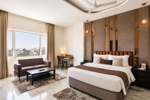 a hotel room with a bed and a desk at Hotel Star City in Chennai