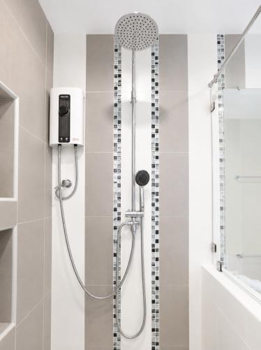 a shower with a shower head in a bathroom at Chaolao Cabana Resort in Chao Lao Beach