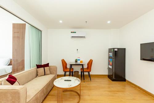 a living room with a couch and a table at The BHA Riverside in Danang