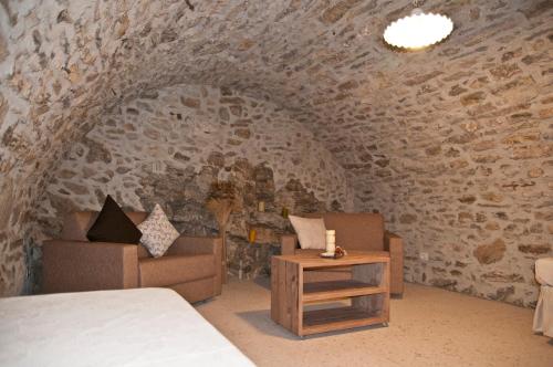 a bedroom with a bed and a couch and a table at Villa delle Querce in Tremosine Sul Garda