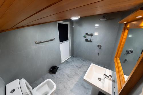 a bathroom with two sinks and two toilets at Lion See Hotel - Sigiriya in Sigiriya