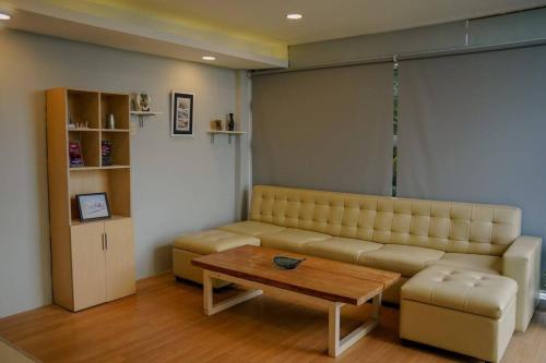 a living room with a couch and a coffee table at Mamima BnB in Caramoan