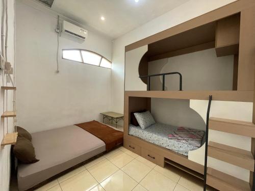 a bedroom with two bunk beds and a window at Lanina homestay in Ipi