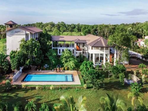 an aerial view of a house with a swimming pool at Four Points Resort - Anuradhapura in Anuradhapura