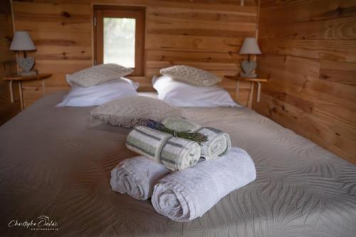 a bedroom with two beds with towels on them at Roulotte de Combeplane in Carnac-Rouffiac