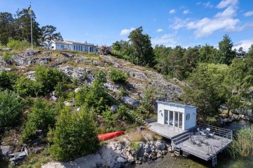 an aerial view of a tiny house on a hill at Spectacular lake plot, Stockholm archipelago in Dalarö