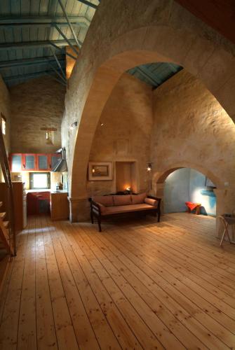 a large room with a couch in the middle of a room at Milio's House in Roústika