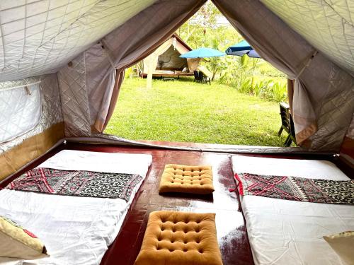 a tent with two beds and a table in a field at Hen Camping- Coffee --------- Free if you have tent in Ninh Binh