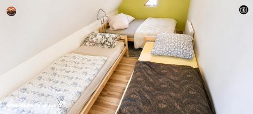 a small room with two beds and a mattress at Vilimu Sodyba - White Hall in Kriukai