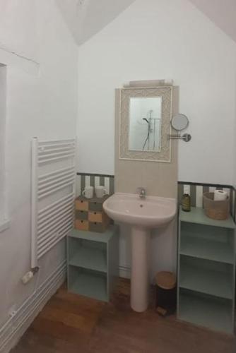 a bathroom with a sink and a mirror at Le Figuier , Domaine La Capitainerie in Bazoges-en-Pareds