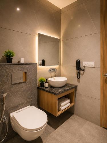a bathroom with a sink and a toilet and a mirror at Hotel Nayyar Regency Near Golden temple in Amritsar