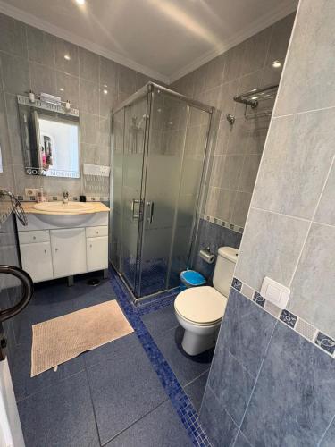 a bathroom with a shower and a toilet and a sink at Orlando Costa Adeje in Adeje