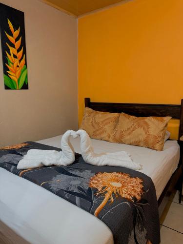 two towels on a bed in a room at Cabinas Arenal Z-13 in Fortuna