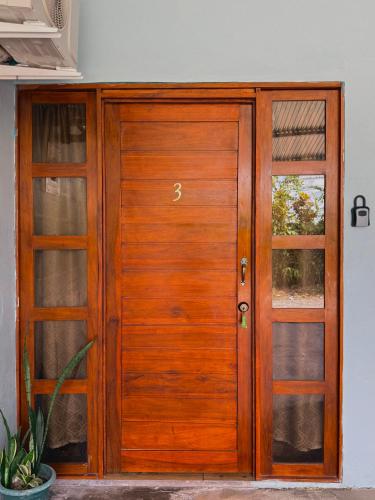 a wooden door with two windows in a house at Cabinas Arenal Z-13 in Fortuna