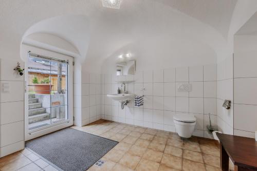 a bathroom with a toilet and a sink at Landhaus Waldesruh in Oetz