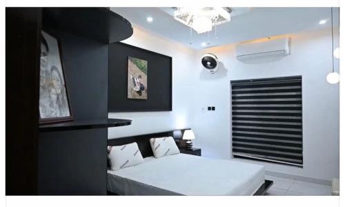 a bedroom with a white bed in a room at Meria town attock in Attock