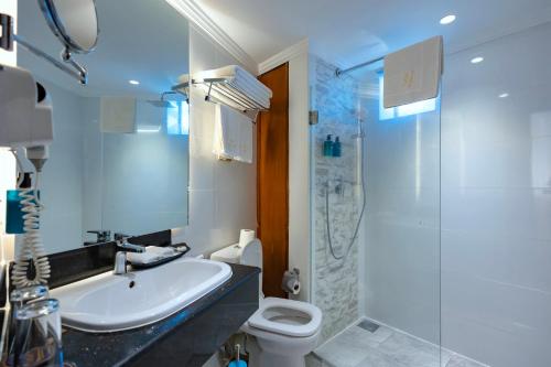 a bathroom with a sink and a toilet and a shower at Premium Inn Mombasa City in Mombasa