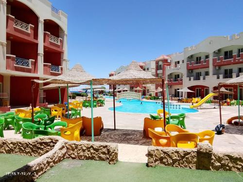a resort with a pool with chairs and slides at La Sirena Hotel & Resort - Families only in Ain Sokhna