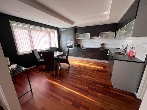 a kitchen with a table and chairs in a room at Apartment close to city center in Haugesund
