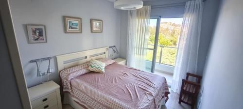 a small bedroom with a bed and a window at Apartamento Aguamar in Denia