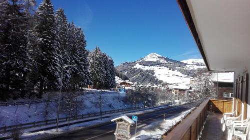 a view of a snow covered mountain from a balcony at Garnì La Grambla in Selva di Val Gardena