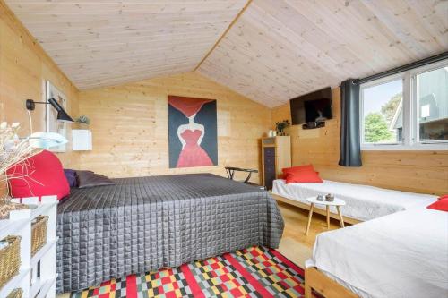 a room with two beds and a tv in it at 8997-Orsted-Rougsovej-326-B in Ørsted